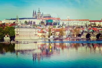 Vintage retro hipster style travel image of  Charles bridge over Vltava river and Gradchany Prague Castle and St. Vitus Cathedral