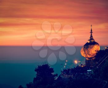 Vintage retro effect filtered hipster style image of Golden Rock - Kyaiktiyo Pagoda - famous Myanmar landmark, Buddhist pilgrimage site and tourist attraction, Myanmar