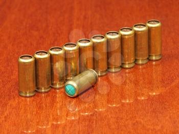 A gas cartridges row on a polished table surface.