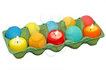 Coloreaster eggs and multicolored candle isolated on white background.