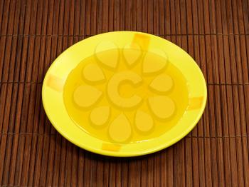 Honey in yellow plate on a wooden surface.