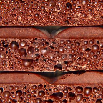 Porous chocolate pieces taken closeup as background.