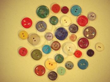 Set of retro buttons on yellow fabric suitable as background taken closeup.