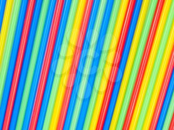 Multicolored cocktail straws lying in a row.Background.