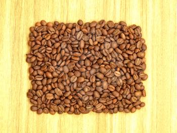 Coffee beans on a wooden background.