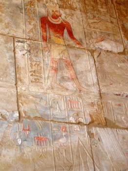 Old wall in the Karnak temple with ancient images.