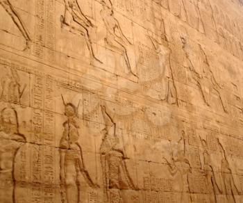 Old wall in the Karnak temple with ancient images.