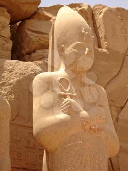 Statue of Ramses with the keys of life in his hands in the Karnak temple.