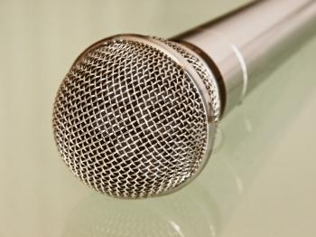 Metallic microphone taken closeup.
