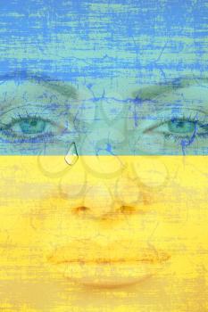 Crying Ukraine.Pretty woman face with tear on Ukranian flag background.