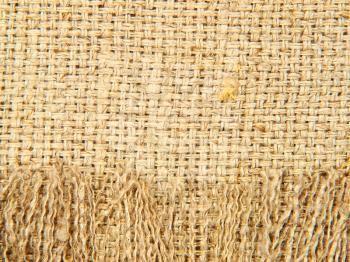 Natural linen texture with fringe taken closeup as abstract background.