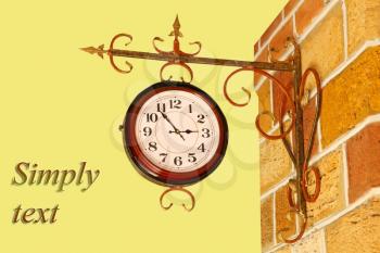 Vintage watch and brick wall with text on yellow background.