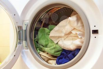 Clothes inside of washing machine taken closeup.