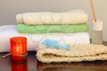 Towel stack with bast and dolphin form soap in the shower.