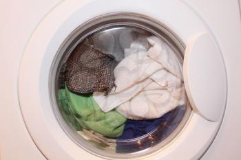 Various clothes in washing machine taken closeup.