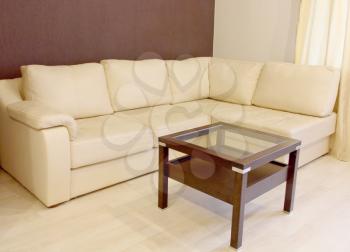 White corner leather sofa and coffee table in room.