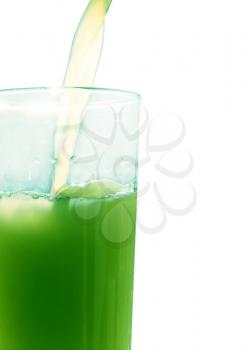 Green juice pouring in glass on white background taken closeup.
