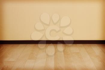 Empty room with clean wall and wooden floor as background.Toned image.