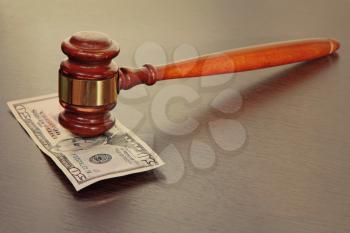 Judge gavel and fifty dollars banknote on wooden table.Toned image.