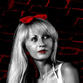 Beautiful blonde on grunge brick wall background.Digitally generated image.