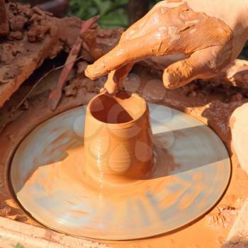 Potter hand taken closeup.Process of the pottery manufacturing.