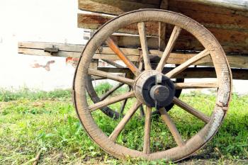 Retro wooden cart wheel taken closeup.Toned image.