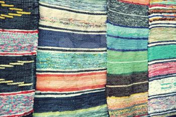 Multicolored handmade rugs as abstract background.Toned image.