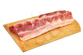 Raw pork ribs on wooden cutting board isolated on white background.