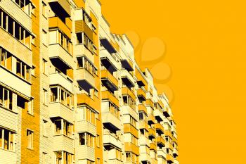Modern apartment building on yellow background.Digitally generated image.