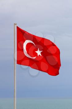 Turkish flag on blue sky background taken closeup.