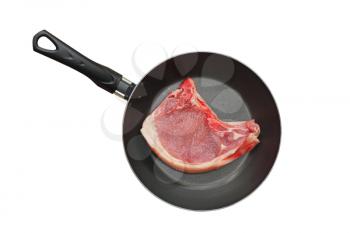 Appetizing pork meat in frying pan isolated on white background.Top view.