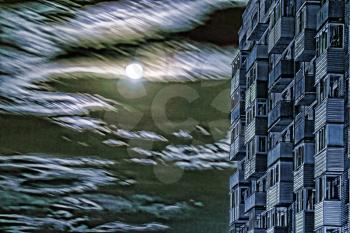 Multistory house against of dramatic full moon sky.Digitally altered image.