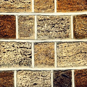 Limestone brick wall taken closeup as abstract background.