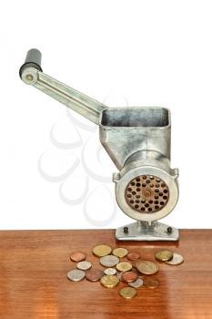 Financial concept.Meat grinder and coins on wooden table and white background.