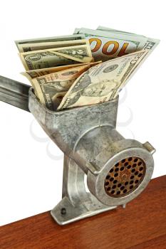 Money concept with dollar banknotes in meat grinder on wooden table taken closeup.