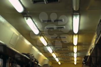 Train car interior with rows of lamps.Toned and blurred image.