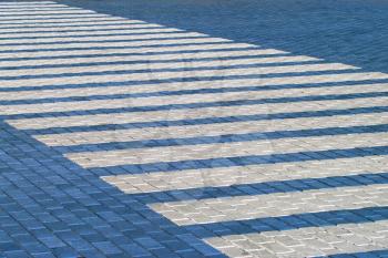 Pedestrian crossing traffic sign.Zebra crosswalk on blue tiles road.
