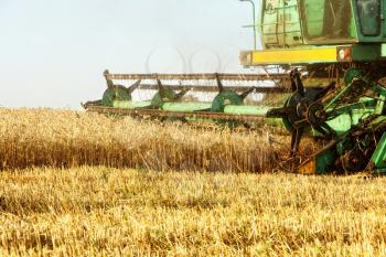Combine harvester machine tractor in agriculture field taken closeup.
