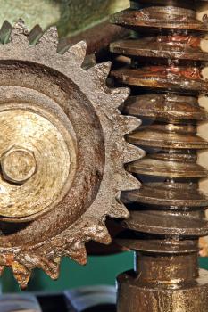 Gear wheel, cogs and screw of old machine taken close up.
