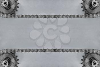 Metal cogwheels and double chain on grey background with empty space for text.Technology background.