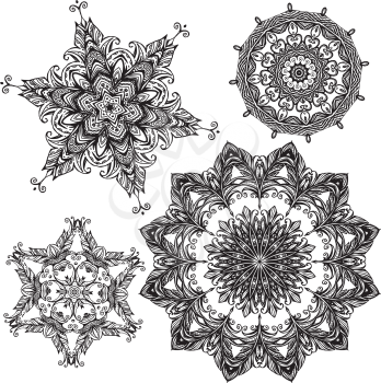 Set of 4 black color round ornaments isolated on white background, kaleidoscope floral patterns in indian style. Mandala.