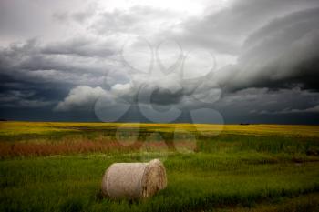 Storm Clouds Saskatchewan with hay bale and field