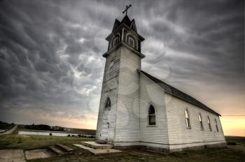 Storm Clouds Saskatchewan with old wooden church in foreground