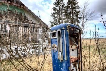 Old Vintage Gas Pump and Abandoned house