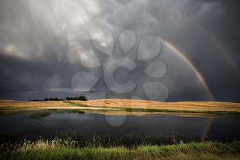 Saskatchewan Storm Rainbow overfield and slough pond hail