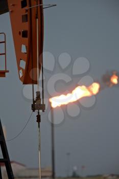 Oil Field  flame burn off gas oil jack well pump