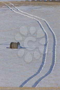 Hay Bale and tractor tracks Saskatchewan Canada winter cold