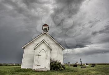 Old Country Church in Saskatchewan Canada with storm clouds