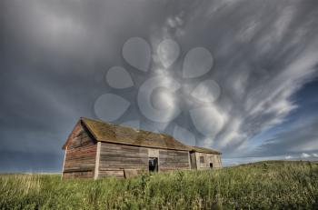 Abandoned Farm with storm clouds in the Canadian Prairie