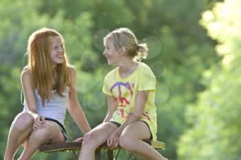 Girls sitting on picnic table